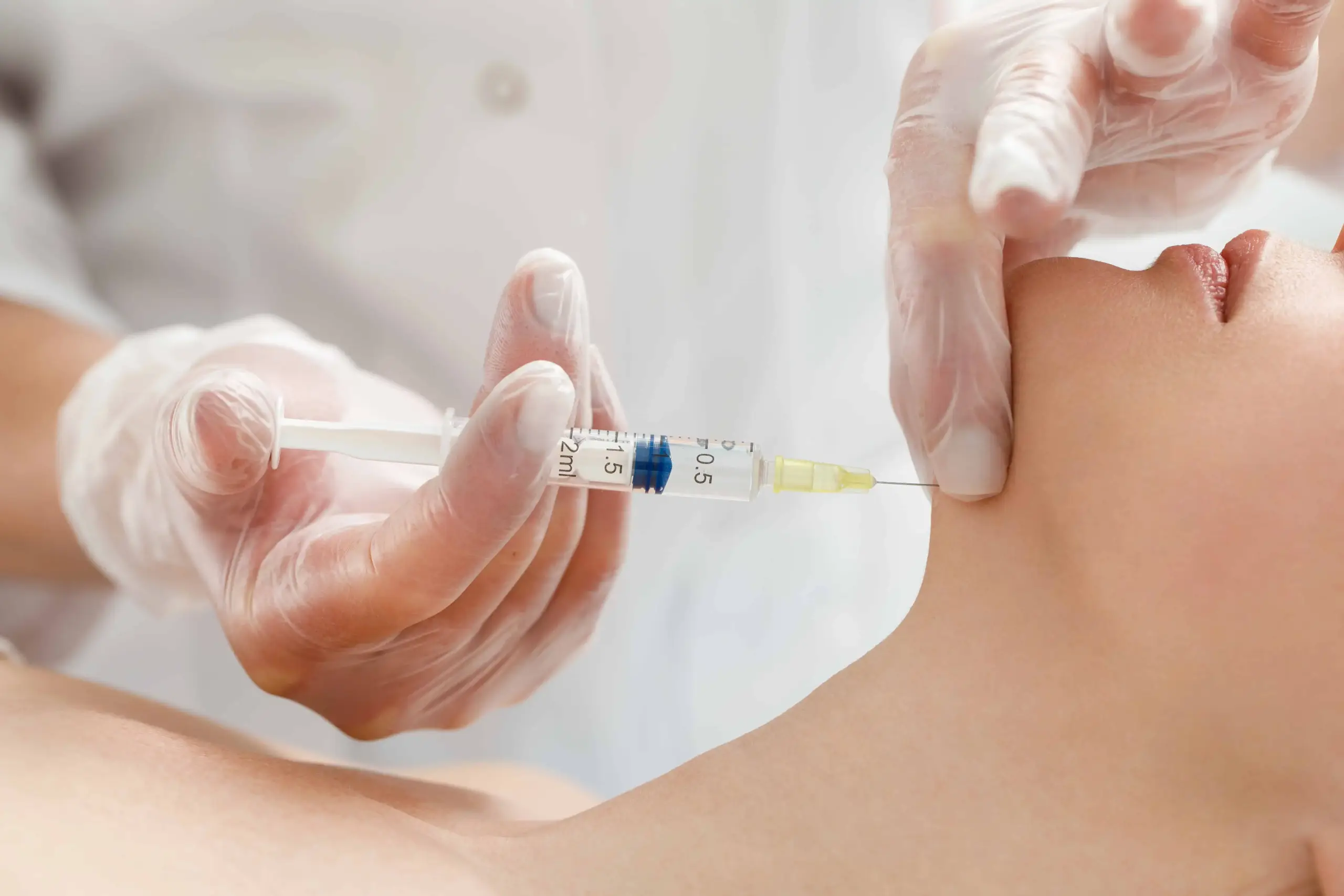 A woman is receiving Kybella treatment at New Look Skin Centre in Glendale, CA